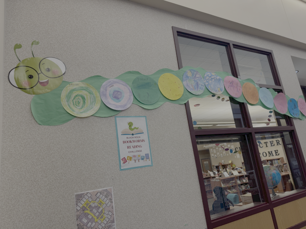 A colorful caterpillar made of paper circles and a smiling face, displayed in a library for a reading challenge.